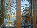 Кованая решетка на окно с растительным орнаментом - фото